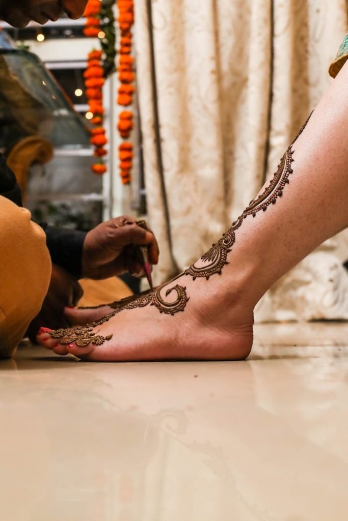 A Person Getting a Henna Tattoo on Her Feet